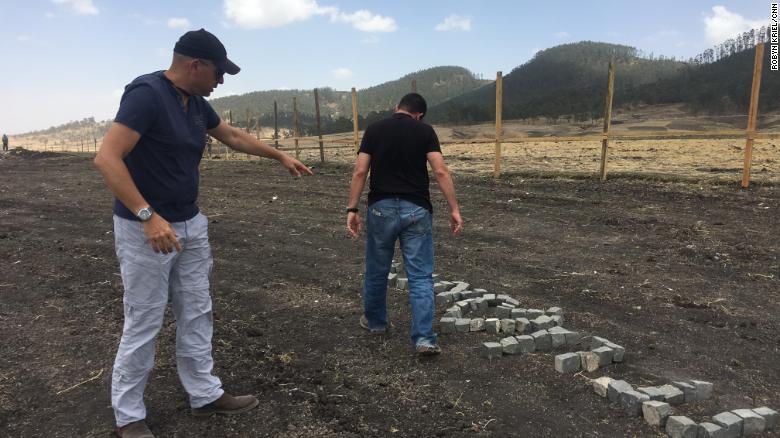 Moshe Biton and Ilan Matsliah place stones spelling out their dead brothers names in Hebrew at the site.