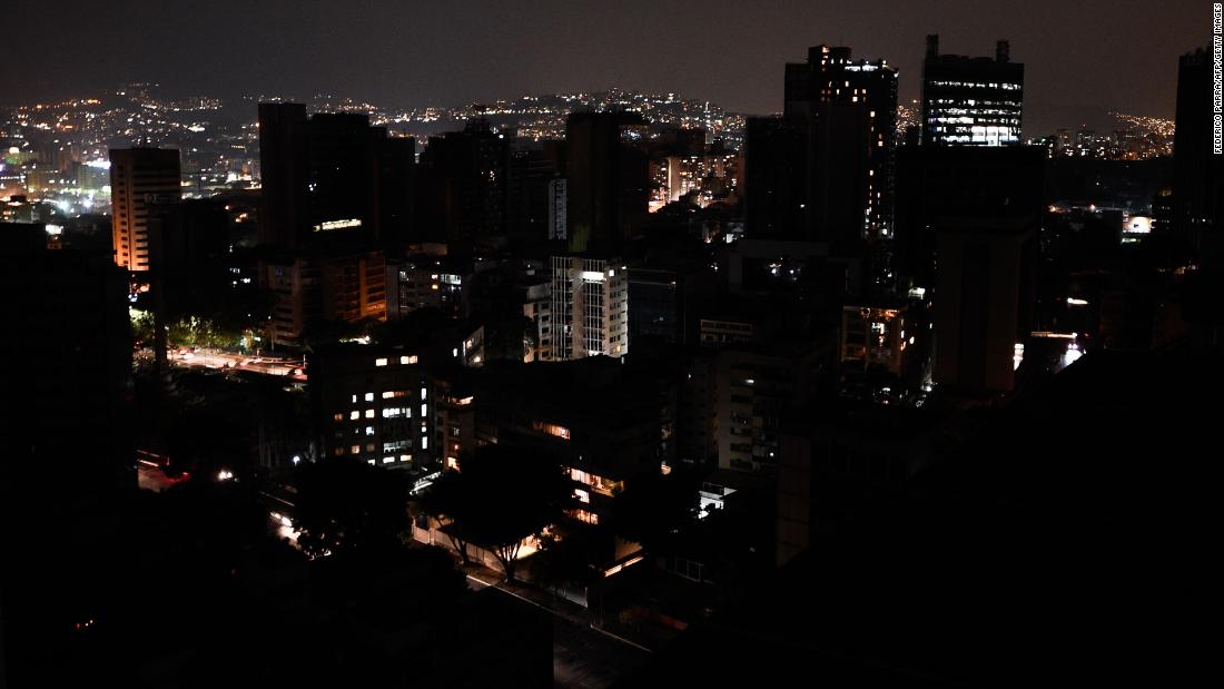 TOPSHOT - General view of Altamira neighborhood partially illuminated during a power outage in Caracas, Venezuela, on March 26, 2019. - Venezuela decreed a 24-hour holiday Tuesday to cope with a new near-nationwide blackout that the government alleged was caused by an &quot;attack&quot; targeting its main hydroelectric plant. (Photo by FEDERICO PARRA / AFP)        (Photo credit should read FEDERICO PARRA/AFP/Getty Images)