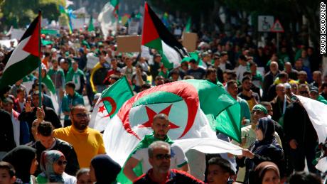 Demonstrators march with national flags during a protest in Algiers, Algeria, March 29, 2019. Algerians taking to the streets for their sixth straight Friday of protests aren&#39;t just angry at their ailing president, they want to bring down the entire political system that has sustained him. (AP Photo/Toufik Doudou)