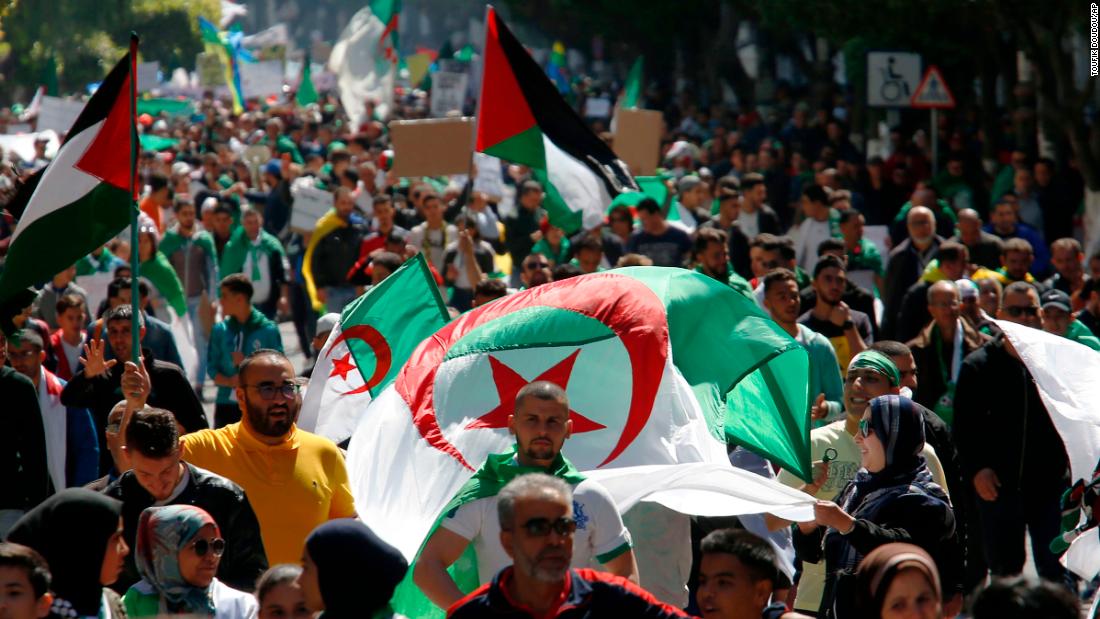 Demonstrators march with national flags during a protest in Algiers, Algeria, March 29, 2019. Algerians taking to the streets for their sixth straight Friday of protests aren&#39;t just angry at their ailing president, they want to bring down the entire political system that has sustained him. (AP Photo/Toufik Doudou)