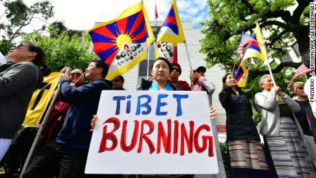 Tibetan Flags are displayed as people gather to protest in front of the Consulate General of China in Los Angeles, California on March 10.