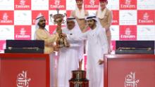 DUBAI, UNITED ARAB EMIRATES - MARCH 30: Sheikh Mohammed bin Rashid Al Maktoum (L), Vice President and Prime Minister of the UAE and Ruler of Dubai, receives the trophy after his horse Thunder Snow   the Dubai World Cup at Meydan Racecourse on March 30, 2019 in Dubai, United Arab Emirates. (Photo by Francois Nel/Getty Images)