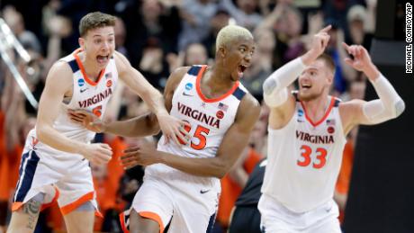 Virginia&#39;s Mamadi Diakite, center, reacts with teammates Kyle Guy and Jack Salt (33) after hitting a shot to send the game into overtime in the men&#39;s NCAA Tournament college basketball South Regional final game against Purdue, Saturday, March 30, 2019, in Louisville, Ky. (AP Photo/Michael Conroy)