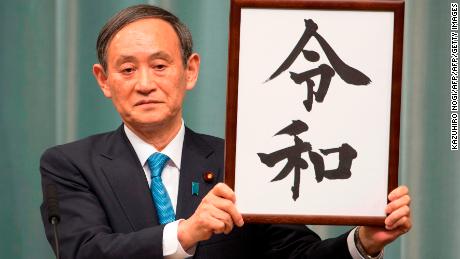 Japan&#39;s Chief Cabinet Secretary Yoshihide Suga announces the new era name, &quot;Reiwa,&quot; during a press conference in Tokyo.