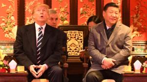 US President Donald Trump (L) looks up as he sits beside China&#39;s President Xi Jinping during a tour of the Forbidden City in Beijing on November 8, 2017. 
US President Donald Trump toured the Forbidden City with Chinese leader Xi Jinping on November 8 as he began the crucial leg of an Asian tour intended to build a global front against North Korea&#39;s nuclear threats. / AFP PHOTO / Jim WATSON        (Photo credit should read JIM WATSON/AFP/Getty Images)