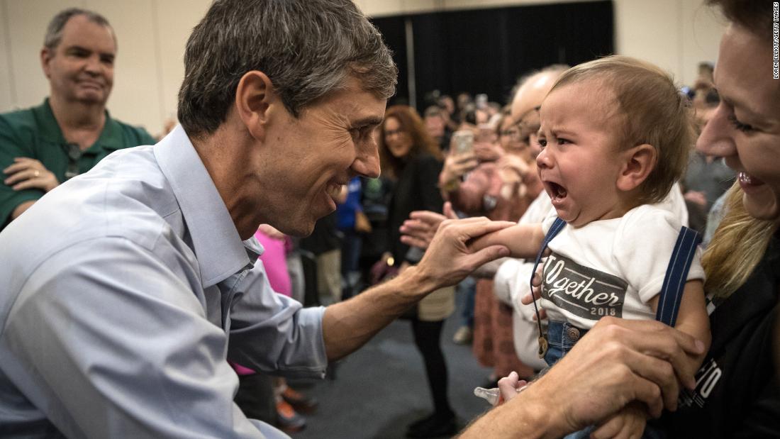 O&#39;Rourke tries to cheer up a crying baby at a campaign rally in Conroe, Texas, in October 2018.