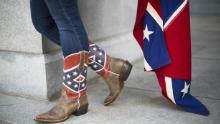 Pro-confederate flag demonstrators Alice Horky wears confederate battle flag cowboy boots as she protests atop the South Carolina State House steps in Columbia, South Carolina, June 27, 2015. There has been a growing clamor for the flag -- branded &quot;a reminder of systemic oppression and racist subjugation&quot; by President Barack Obama on Friday -- to be removed from the grounds of the state house in Columbia.