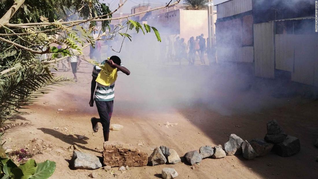 A protester retreats from tear gas during an anti-government demonstration on February 24.