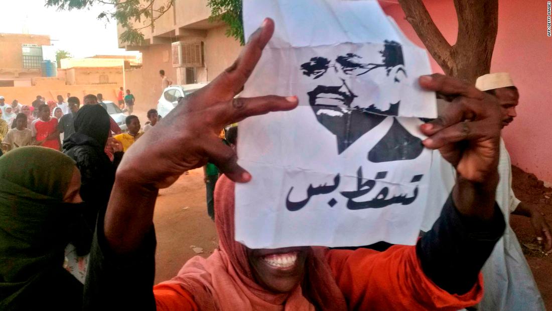 A protester carries a Bashir portrait on February 8. It reads, &quot;Down and that is all.&quot;