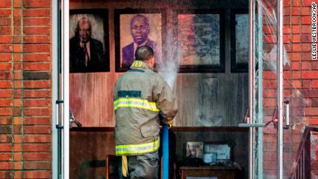 A firefighter stands outside the door to Mt. Pleasant Baptist Church on Thursday. 