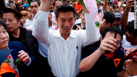 Thailand&#39;s Future Forward Party leader Thanathorn Juangroongruangkit is mobbed by his supporters at a police station in Bangkok on Saturday.