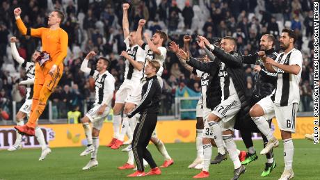 Juventus players celebrate after beating Milan 2-1 to close in on the Serie A title. 
