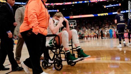 Baylor forward Lauren Cox is assisted off the court after she went down with injury.