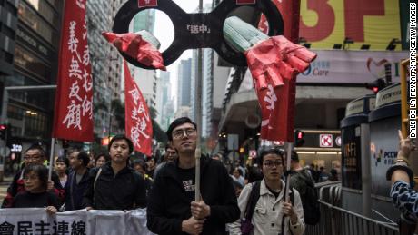 Protesters march along a street during a rally in Hong Kong on March 31, 2019, to protest against the government&#39;s plans to approve extraditions with mainland China, Taiwan and Macau.