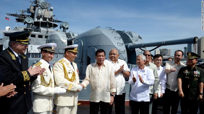 Philippines' President Rodrigo Duterte (4th L) shake hands with Russia's Rear Admiral Eduard Mikhailov (3rd L) onboard the Russian anti-submarine navy ship Admiral Tributs in Manila on January 6, 2017. 