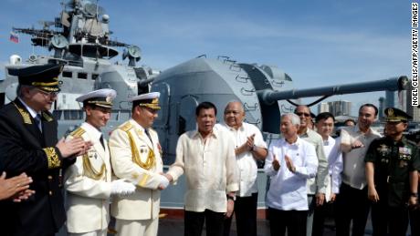 Philippines&#39; President Rodrigo Duterte (4th L) shake hands with Russia&#39;s Rear Admiral Eduard Mikhailov (3rd L) onboard the Russian anti-submarine navy ship Admiral Tributs in Manila on January 6, 2017. 