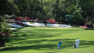 AUGUSTA, GA - APRIL 03:  Justin Rose of England plays a shot on the 13th hole as caddie Mark Fulcher looks on during a practice round prior to the start of the 2018 Masters Tournament at Augusta National Golf Club on April 3, 2018 in Augusta, Georgia.  (Photo by David Cannon/Getty Images)