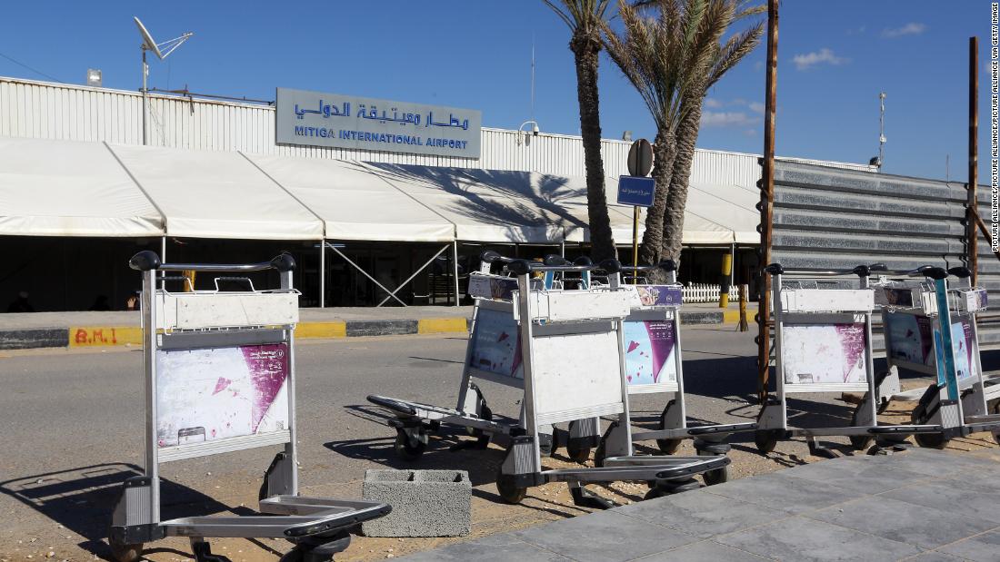 Luggage trolleys lie in front of the gate of the Mitiga airport after it was attacked Monday.