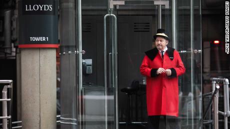 A doorman stands outside the Lloyd&#39;s building in London in 2017.