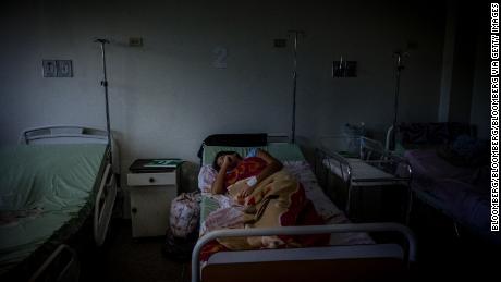 A patient lays on a bed inside the Ana Teresa de Jesus Ponce maternity hospital in Macuto, Venezuela, on Friday, Feb. 22, 2019. Venezuela&#39;s healthcare system, a shining example in Latin America back when the government had the money for ambitious programs, has been crumbling for many years: nearly half the country&#39;s doctors have left and hospital regularly go without the necessary equipment needed to fully function. Photographer: Adriana Loureiro Fernandez/Bloomberg via Getty Images