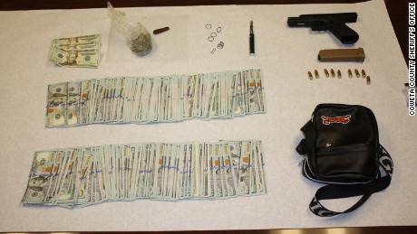 Police say they found $20,160 in cash, drugs and a gun in the rapper&#39;s car. 