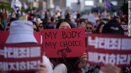 Protesters hold placards reading &quot;Abolish punishment for abortion&quot; as they protest South Korean abortion laws in Gwanghwamun plaza in Seoul on July 7, 2018.