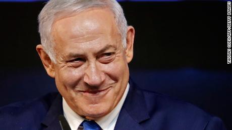 Israeli Prime Minister Benjamin Netanyahu smiles as he addresses supporters on election night at his Likud Party headquarters in the Israeli coastal city of Tel Aviv early on April 10, 2019. The results from yesterday&#39;s vote came despite corruption allegations against the 69-year-old premier and put him on track to become Israel&#39;s longest-serving prime minister later this year.