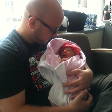 Eric Lohman holds Rosie in the hospital in August, 2012 - within a week of her birth - while awaiting a diagnosis. 