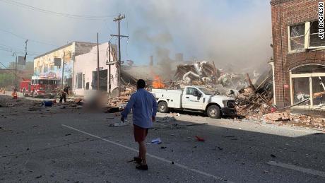 A witness from a building across the street from the blast said, &quot;Half the black is destroyed.&quot; CNN has blurred a figure at center left due to a graphic injury.