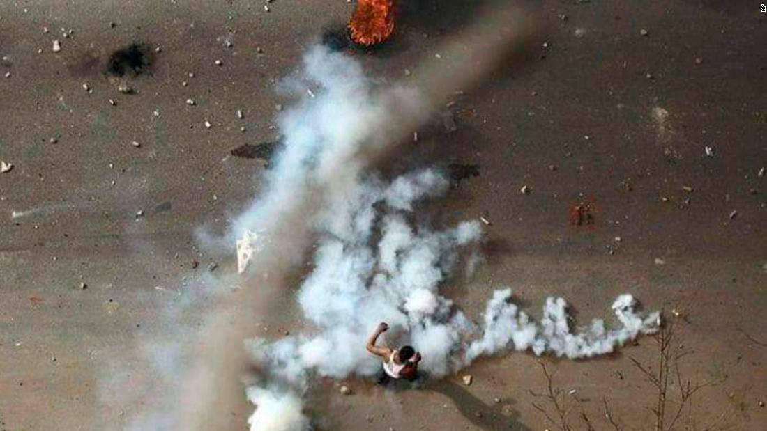 A protester is seen in the midst of tear gas during clashes with security forces in Khartoum in December 2018.