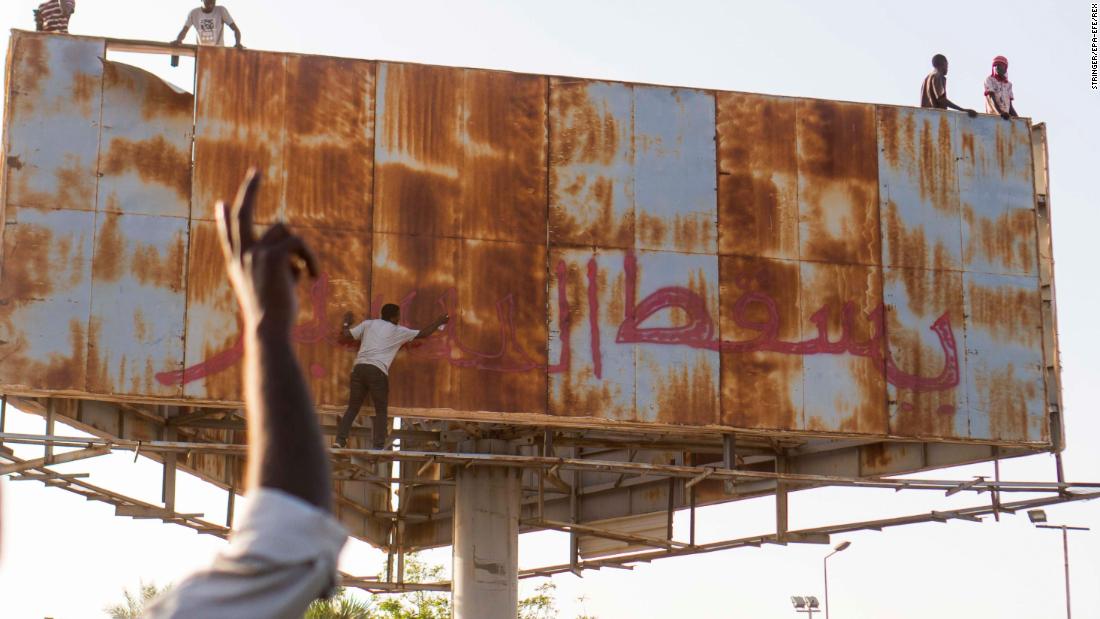 A person writes &quot;Down with Bashir&quot; during an April 9 demonstration in Khartoum.