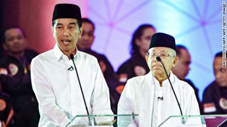 Presidential candidate incumbent President Joko Widodo, left, and his running mate Ma&#39;ruf Amin, right, speak during a live nationwide television debate in Jakarta on January 17, 2019. 