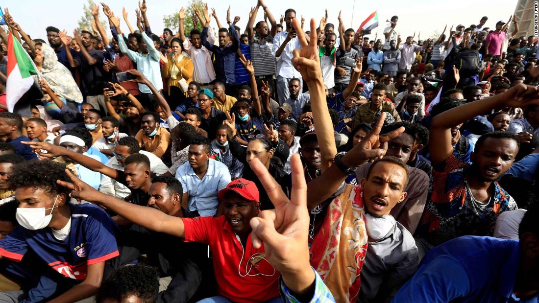 Protesters cheer outside the Defense Ministry in Khartoum on April 11. They were demanding that Bashir step down.