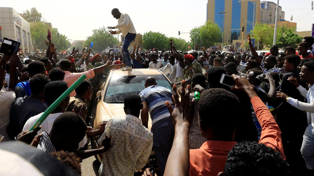 Demonstrators block the vehicle of a military officer on April 11.