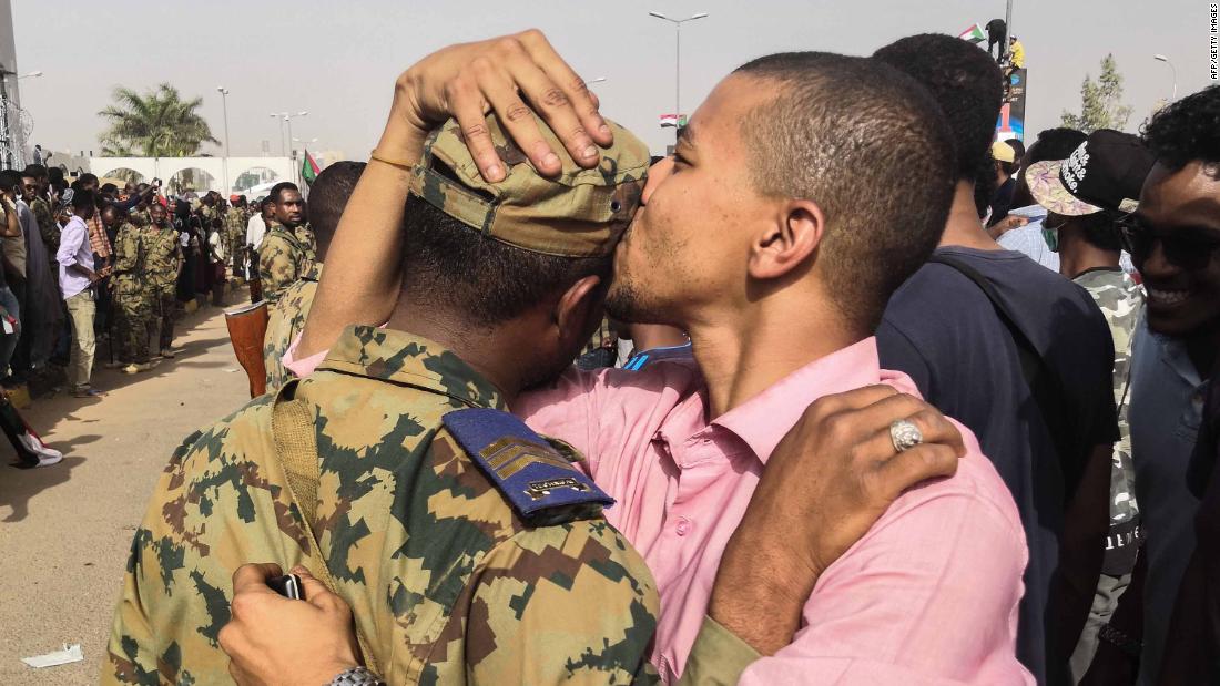 A protester kisses a soldier on the head during a rally in Khartoum on April 11.