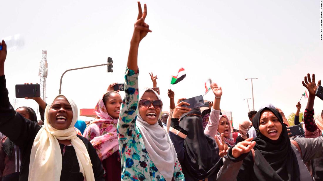 Demonstrators chant slogans as they gather in a street in central Khartoum.