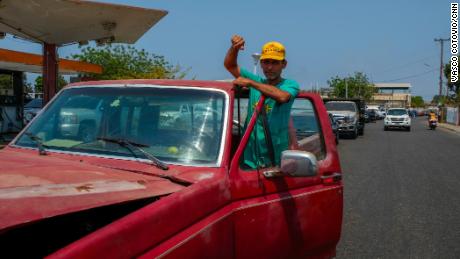 Hinginio Acosta has been pushing his truck through a line of cars, waiting three hours to refill his tank at a gas station in Cabimas.