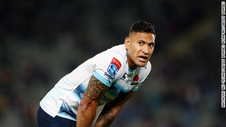 Folau of the Waratahs looks on.