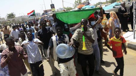 Sudanese protesters celebrate on April 13.