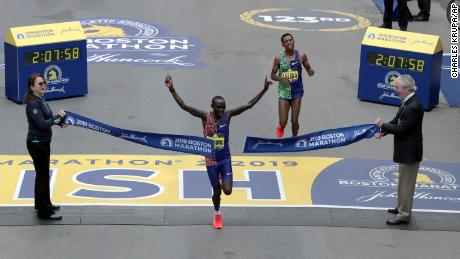 Lawrence Cherono of Kenya breaks the tape to win the 123rd Boston Marathon in front of two-time champion Lelisa Desisa of Ethiopia.