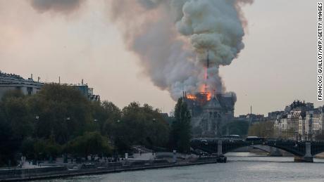 Smokes ascends as flames rise during a fire at the landmark Notre-Dame Cathedral in central Paris on April 15, 2019 afternoon, potentially involving renovation works being carried out at the site, the fire service said. 