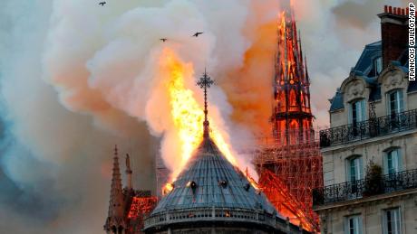 TOPSHOT - Smoke and flames rise during a fire at the landmark Notre-Dame Cathedral in central Paris on April 15, 2019, potentially involving renovation works being carried out at the site, the fire service said. (Photo by FRANCOIS GUILLOT / AFP)