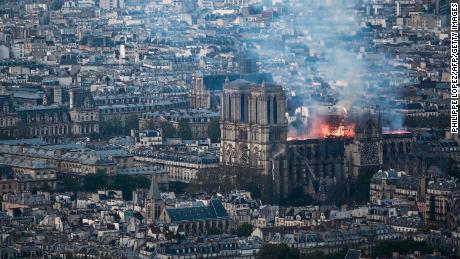 Smoke and flames rise during a fire at the landmark Notre-Dame Cathedral in central Paris on April 15, 2019, potentially involving renovation works being carried out at the site, the fire service said. - A major fire broke out at the landmark Notre-Dame Cathedral in central Paris sending flames and huge clouds of grey smoke billowing into the sky, the fire service said. The flames and smoke plumed from the spire and roof of the gothic cathedral, visited by millions of people a year, where renovations are currently underway. (Photo by Philippe LOPEZ / AFP)        (Photo credit should read PHILIPPE LOPEZ/AFP/Getty Images)