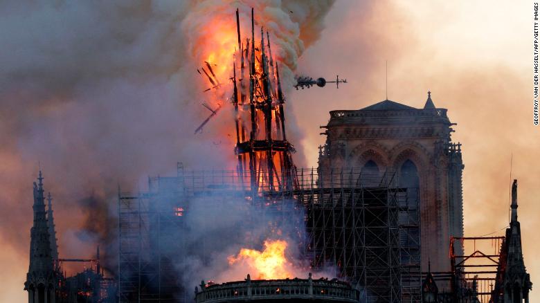 The steeple collapses as smoke and flames engulf the Notre-Dame Cathedral in Paris on April 15, 2019. - A huge fire swept through the roof of the famed Notre-Dame Cathedral in central Paris on April 15, 2019, sending flames and huge clouds of grey smoke billowing into the sky. The flames and smoke plumed from the spire and roof of the gothic cathedral, visited by millions of people a year. A spokesman for the cathedral told AFP that the wooden structure supporting the roof was being gutted by the blaze. (Photo by Geoffroy VAN DER HASSELT / AFP) (Photo credit should read GEOFFROY VAN DER HASSELT/AFP/Getty Images)