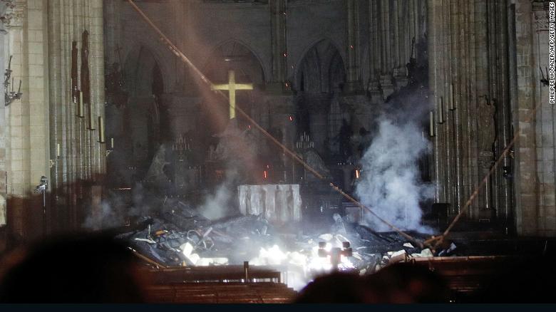 Smoke rises in front of the altar at Notre Dame cathedral after fire engulfed the building.