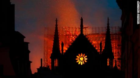 Flames and smoke rise from Notre Dame Cathedral as it burns in Paris.