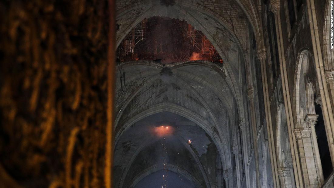 The interior of the cathedral roof is seen smoldering.