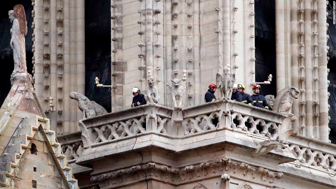 Members of the fire department inspect the cathedral.