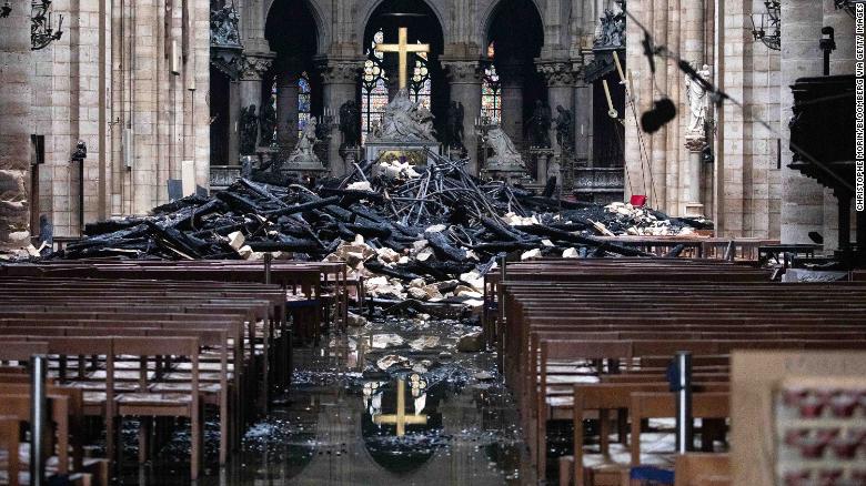 Debris from the roof lies near the altar inside Notre Dame Cathedral in Paris on Tuesday, April 16.