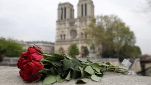 Roses have been laid near Notre-Dame-de Paris Cathedral a day after a fire devastated the cathedral in central Paris on April 16, 2019. - French investigators probing the devastating blaze at Notre-Dame Cathedral on April 15, 2019, questioned workers who were renovating the monument on April 16,  as hundreds of millions of euros were pledged to restore the historic masterpiece. As firefighters put out the last smouldering embers, a host of French billionaires and companies stepped forward with offers of cash worth around 600 million euros ($680 million) to remake the iconic structure. (Photo by ludovic MARIN / AFP)        (Photo credit should read LUDOVIC MARIN/AFP/Getty Images)